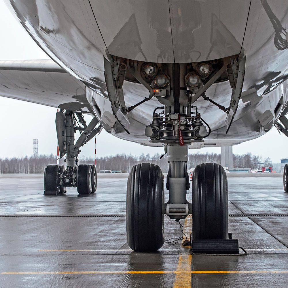 Close up picture of an aircraft's wheels on a tarmac